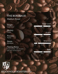 Coffee beans with a coffee roasting information card on a dark background